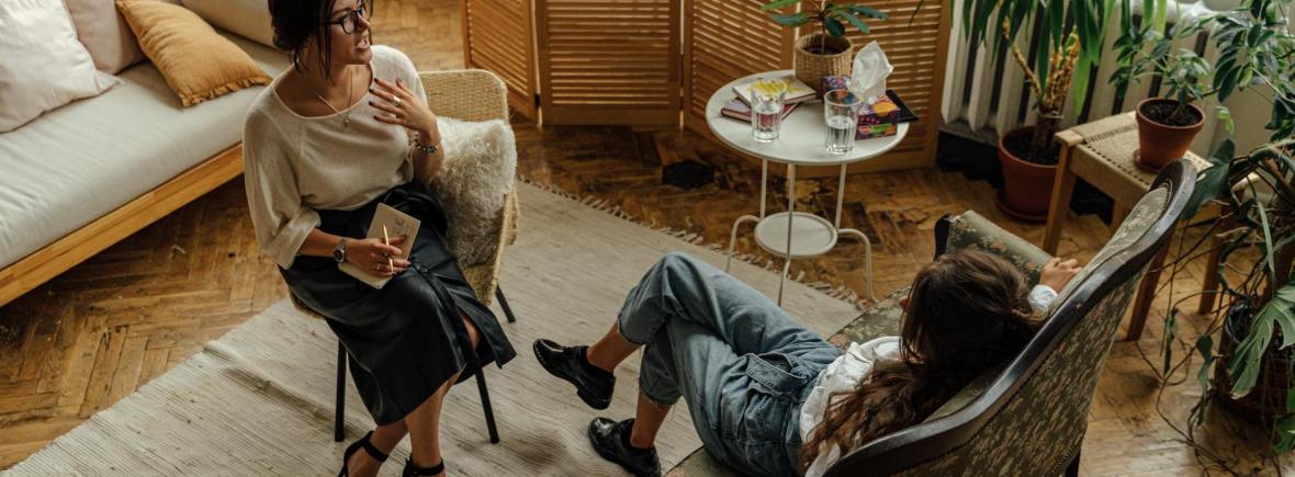 woman in white long sleeve shirt sitting on brown wooden armchair
